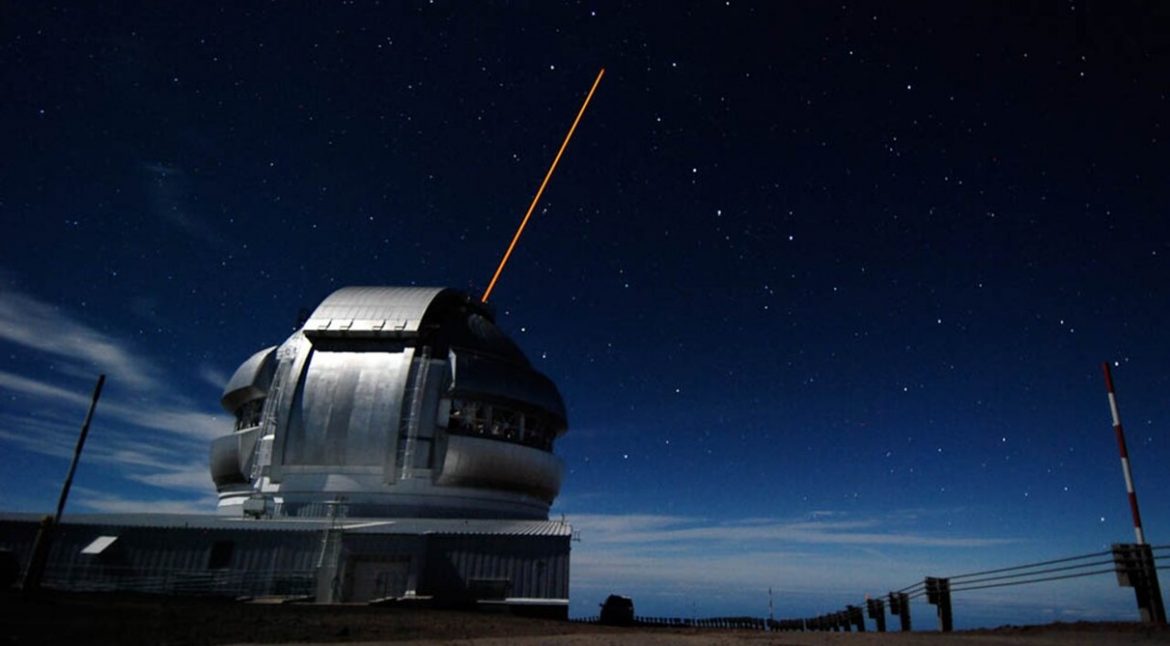 An image taken of the Gemini North Observatory on Mauna Kea while propagating the Adaptive Optics Laser Guide Star into the heart of the Big Dipper. (Credit:Stéphane Courteau/Queen's University)
